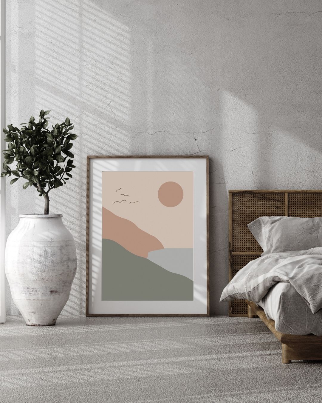 Framed abstract art print in a modern bedroom with a plant and bed.