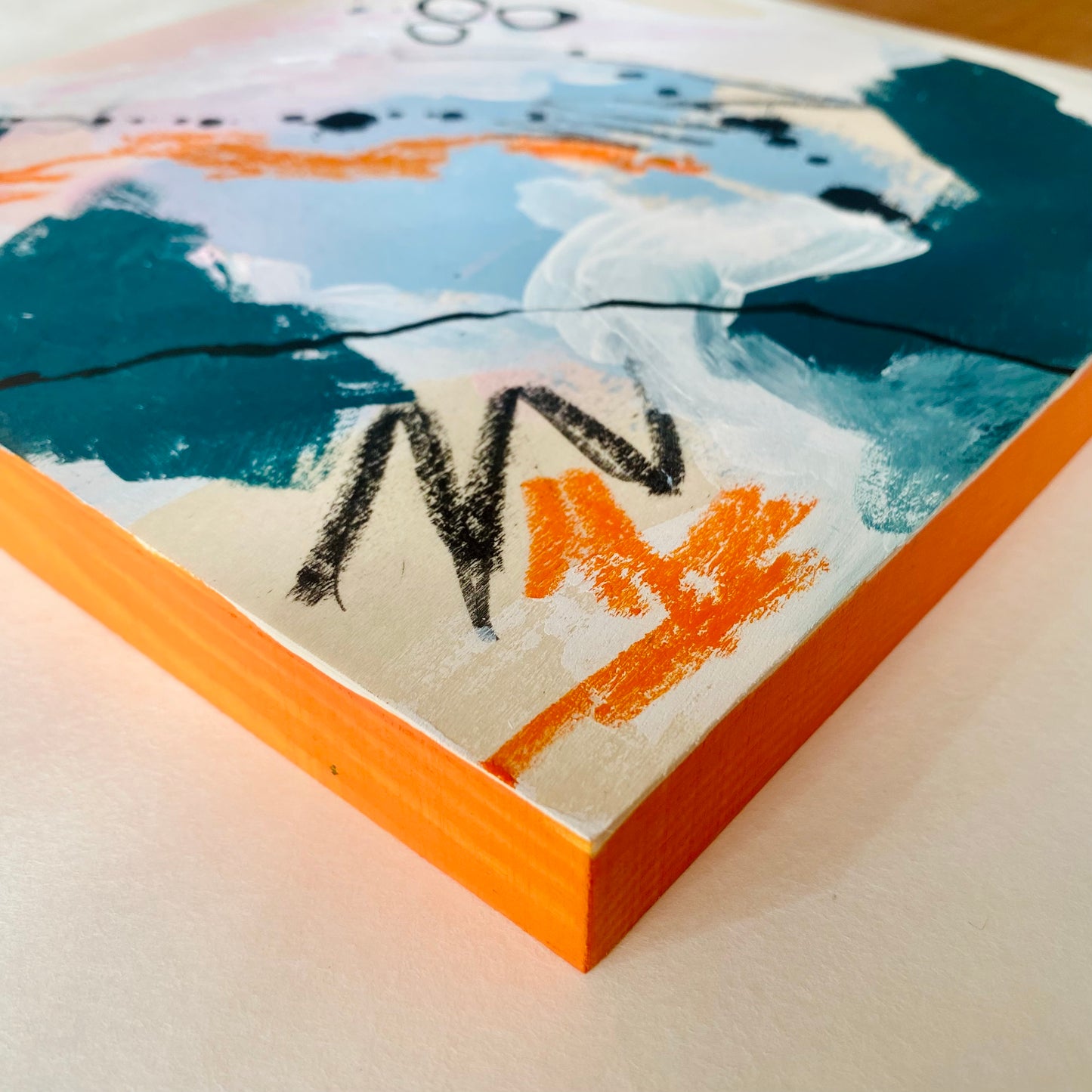 Close-up of a painting with abstract design on a textured surface