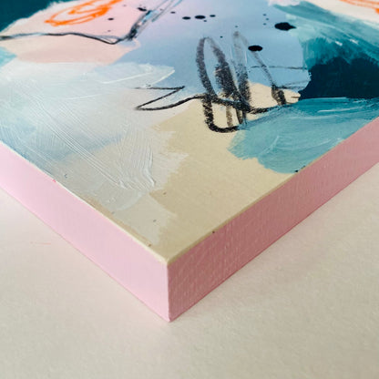 Close-up of a textured painting with abstract brushstrokes on a pink background